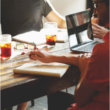 Close up of colleagues sat around a table