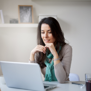 Woman smiling at her laptop screen