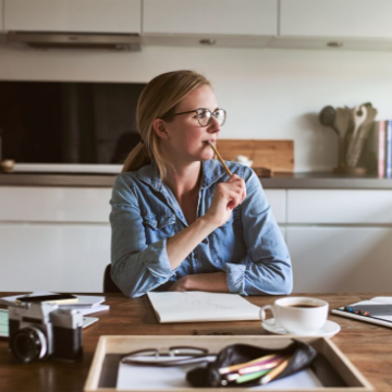 woman sat working at the kitchen table